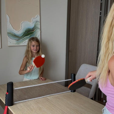 Family playing table tennis with the NetFlex net
