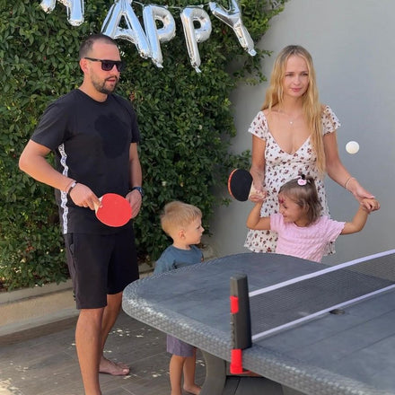 Family playing table tennis with the NetFlex net