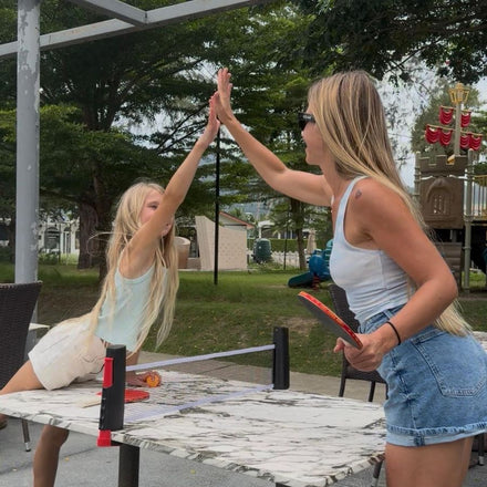 Family playing table tennis with the NetFlex net