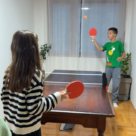 Family playing table tennis with the NetFlex net