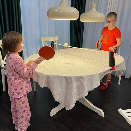 Family playing table tennis with the NetFlex net