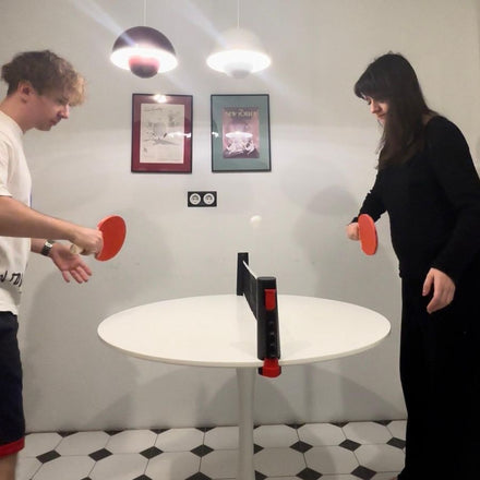 Family playing table tennis with the NetFlex net